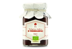 Słoik ekologicznej konfitury truskawkowej 170g z białym papierowym wieczkiem, oznaczony certyfikatem produktu ekologicznego.