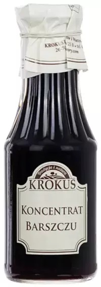 Butelka koncentratu barszczu Krokus w szklanej butelce z białą etykietą i zakrętka z papieru.