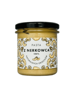 Słoik pasty z nerkowców 100% naturalnych orzechów z czarną zakrętką i etykietą z rysunkami nerkowców.